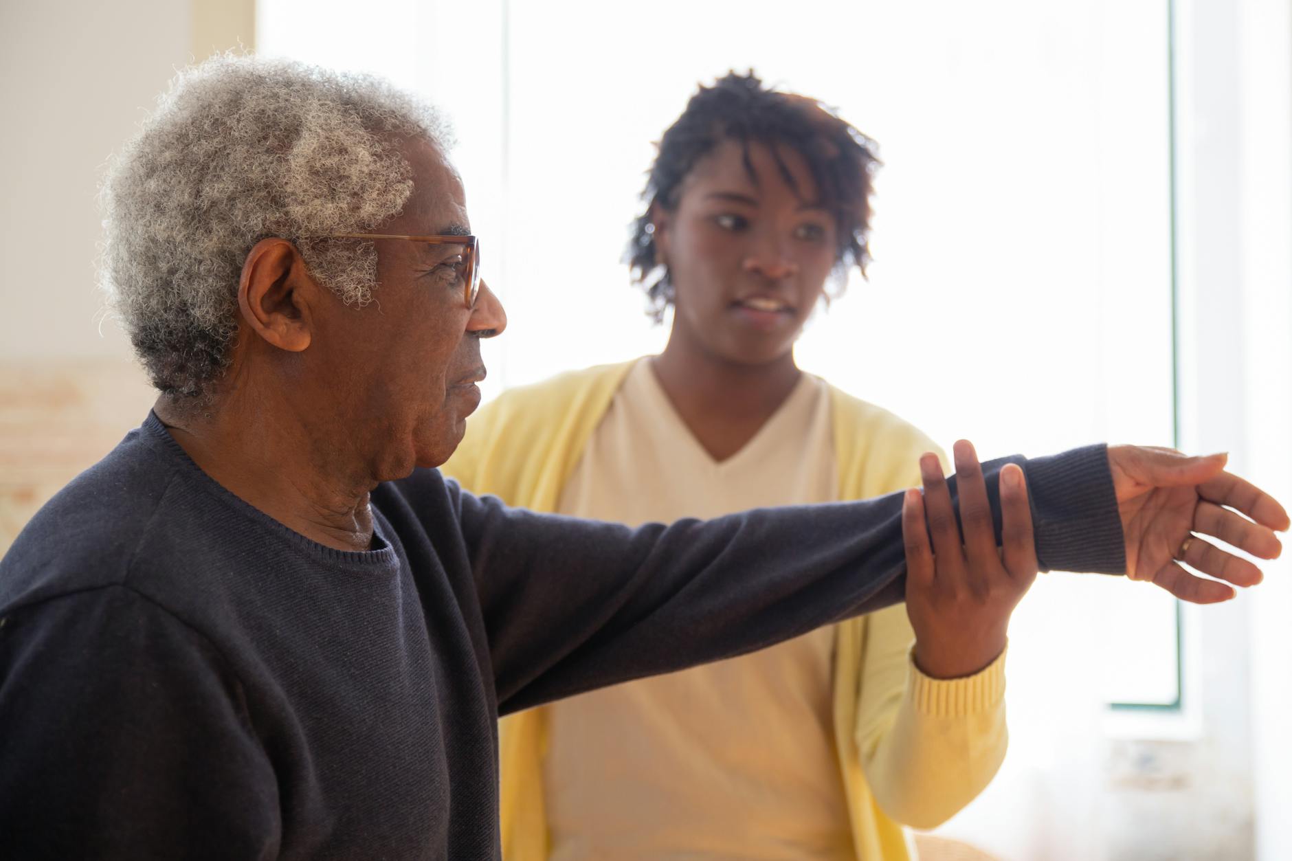 Instructor supporting seniors in a wellness class